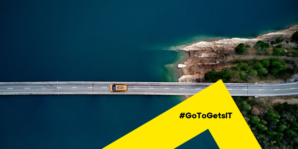 Overhead image of a car driving on a bridge over water, a concept of what presales consultants do, bridging teams to find solutions