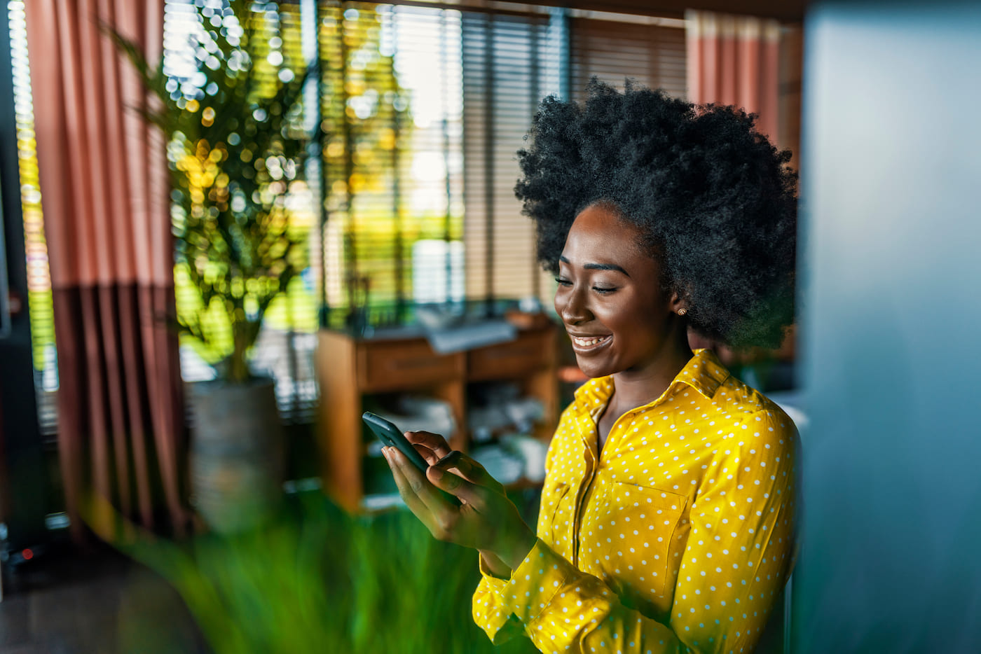 Woman using a mobile device for work, representing a high level of IT operational maturity