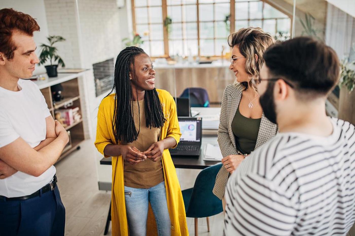 Business group of people standing together talking and laughing