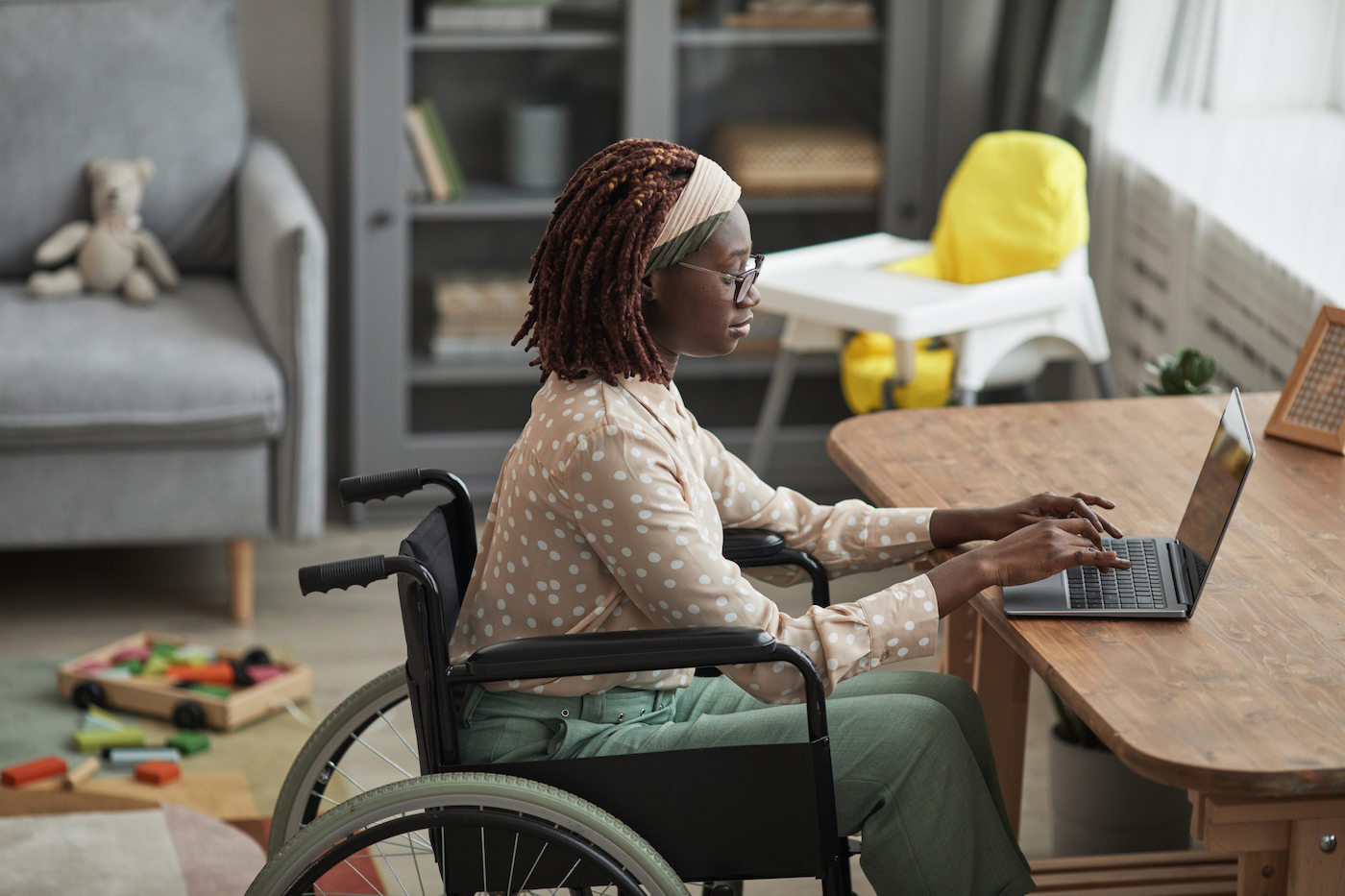 Person working from home on laptop using the sophisticated security controls of remote IT support with GoTo Resolve.