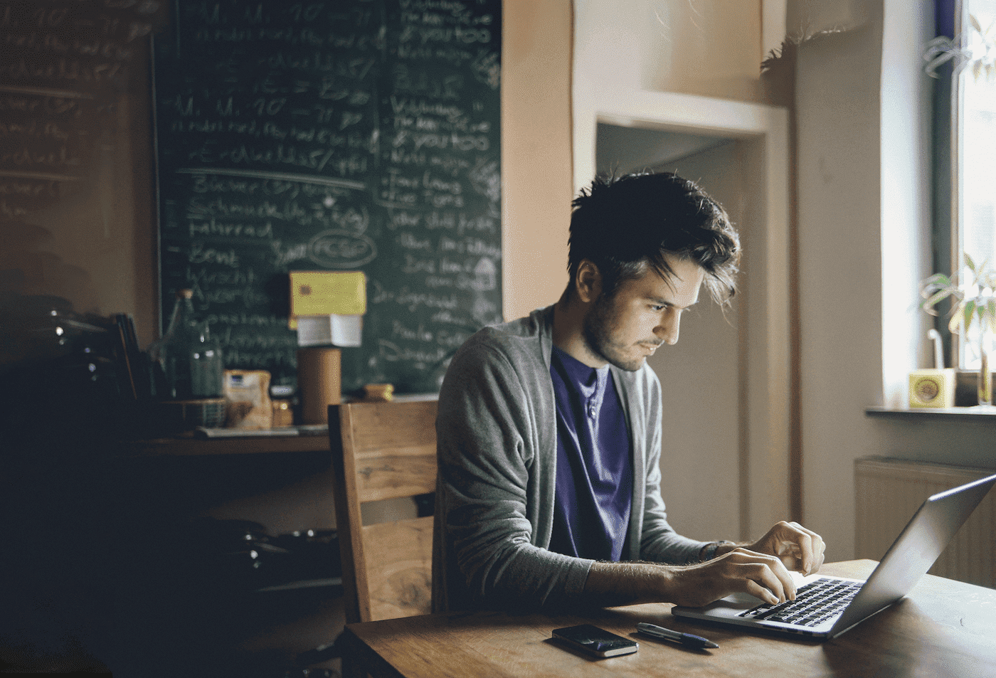Man working on a laptop in a relaxed indoor setting using GoTo Resolve IT support and management built specifically for managed service providers (MSPs)