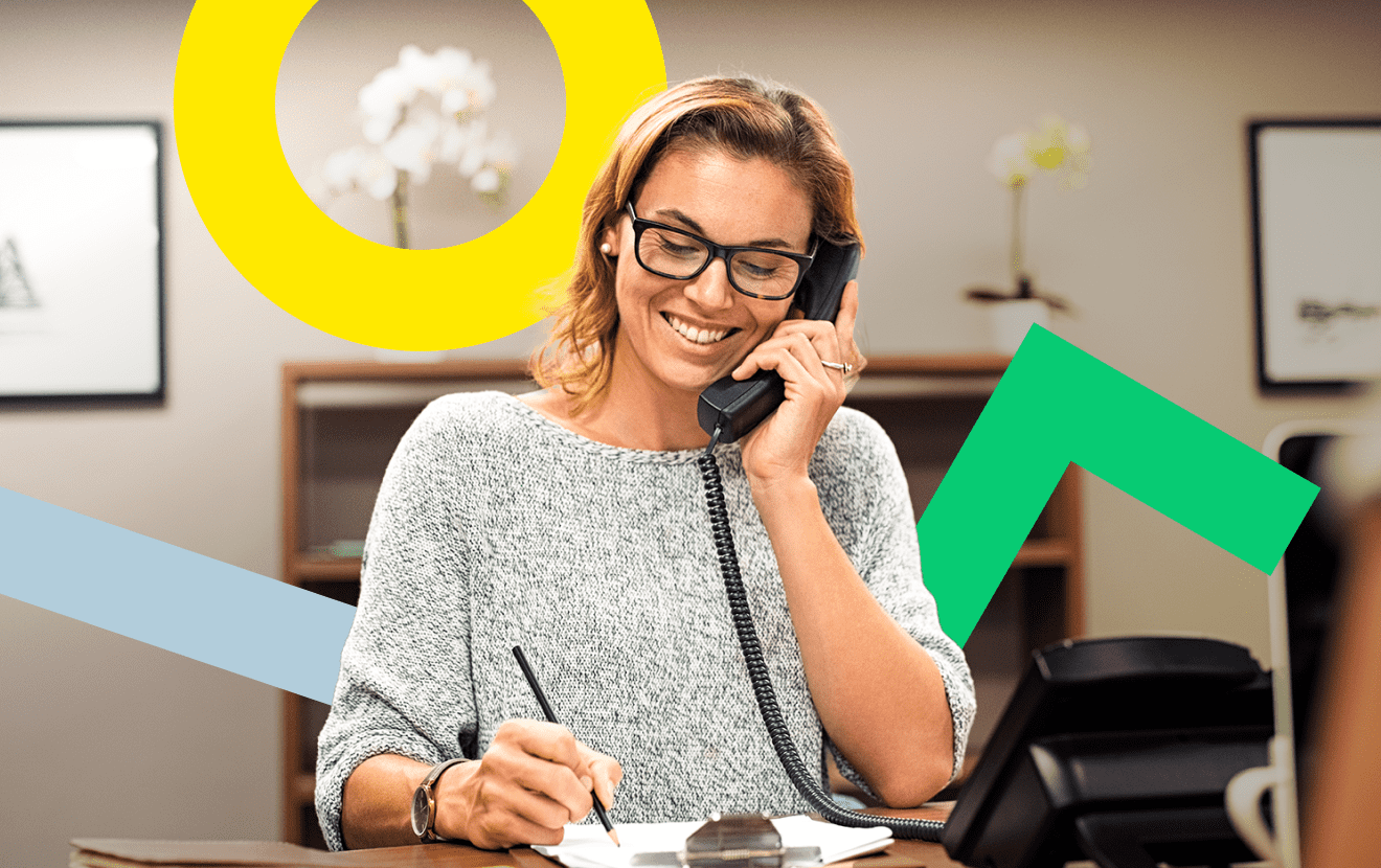 Woman using GoToConnect on her desk phone to easily call domestic and international contacts.