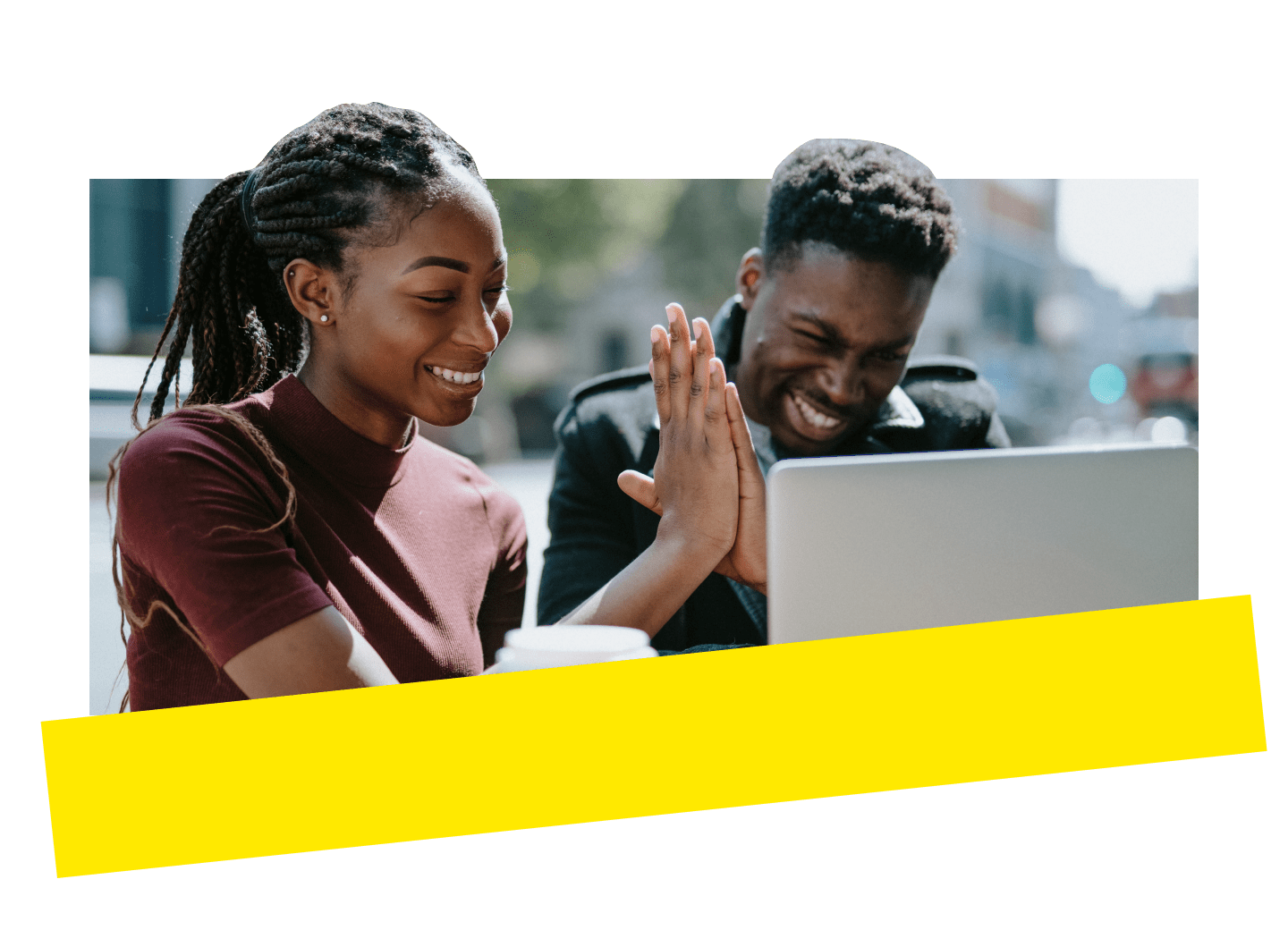 Two coworkers celebrating their collaboration with a high five while working outdoors.